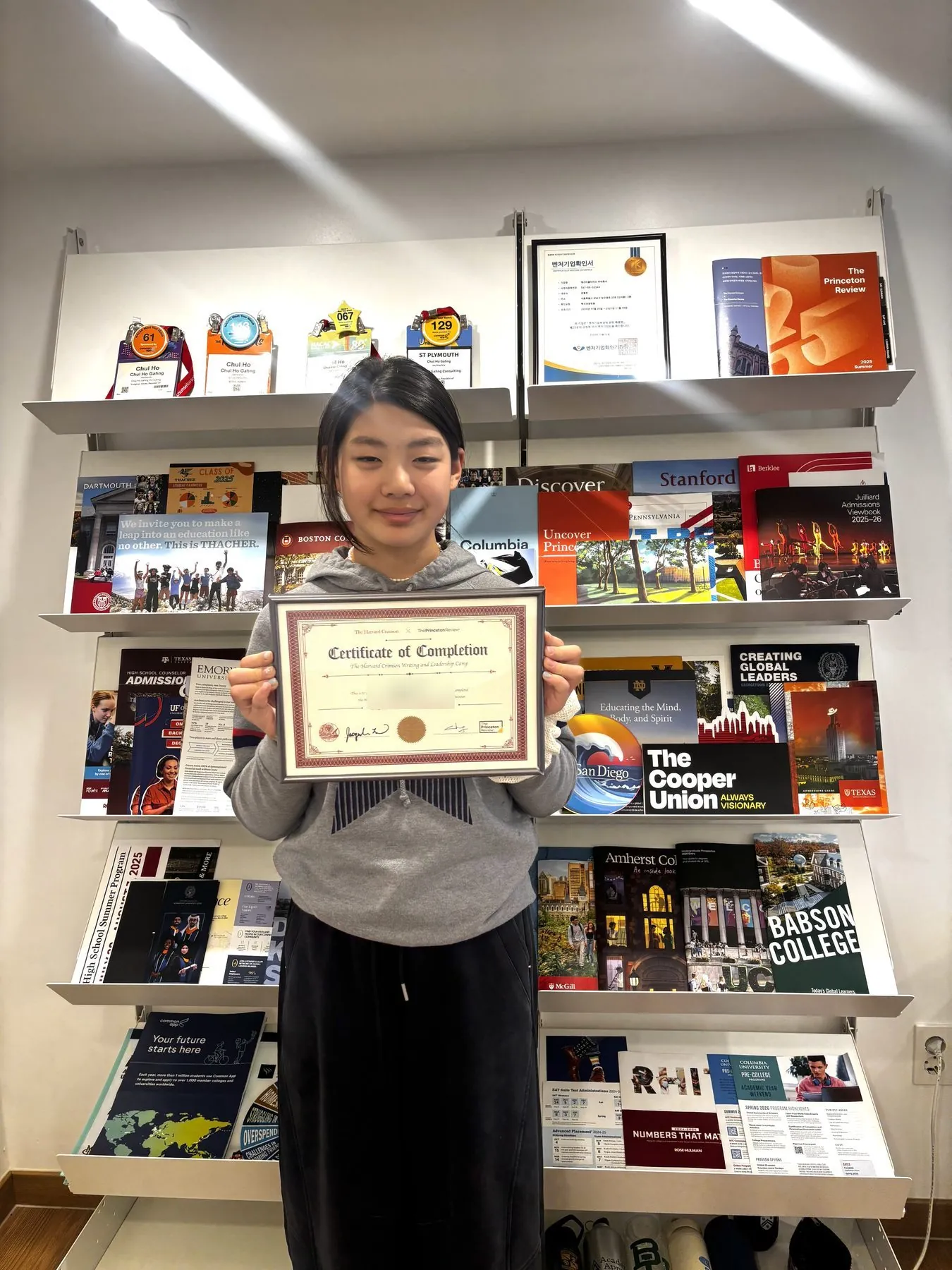 The Harvard Crimson 공식 수료증을 든 학생